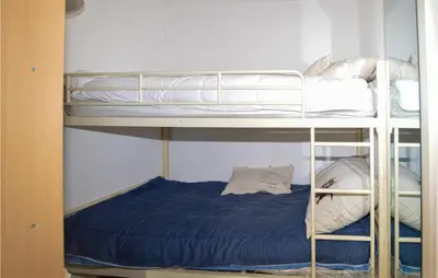 a couple of bunk beds in a room at Awesome Home In Petreto Bicchisano in Petreto-Bicchisano