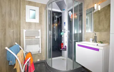 a bathroom with a glass shower and a sink at Awesome Home In Petreto Bicchisano in Petreto-Bicchisano