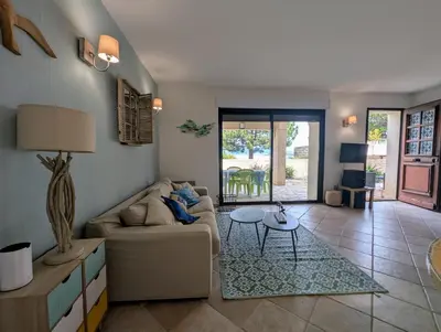 a living room with a couch and a table at La villa Acacia in Coti-Chiavari