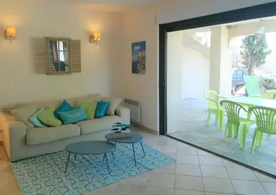 a living room with a couch and a table at La villa Acacia in Coti-Chiavari