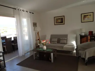 a living room with a couch and a table at Lecci St Cyprien Don Andria in Porto-Vecchio