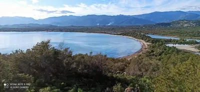a view of a lake with mountains in the background at Lecci St Cyprien Don Andria in Porto-Vecchio