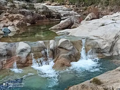 a waterfall in the middle of a river with rocks at Lecci St Cyprien Don Andria in Porto-Vecchio