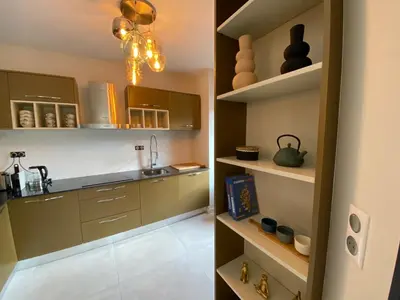 a kitchen with brown cabinets and a sink at Porto-Vecchio, Luxe et lumière, Stanatura in Porto-Vecchio