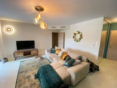 a living room with a couch and a flat screen tv at Porto-Vecchio, Luxe et lumière, Stanatura in Porto-Vecchio