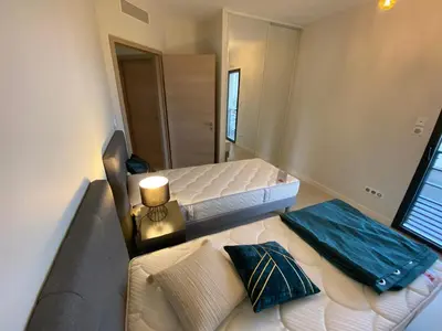 a small bedroom with two beds and a couch at Porto-Vecchio, Luxe et lumière, Stanatura in Porto-Vecchio