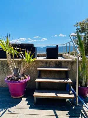 a set of stairs with potted plants on a balcony at Villa vue mer 4 chambres in Olmeto