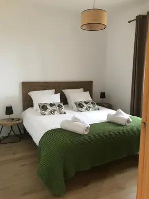 a bedroom with a large bed with towels on it at Villa piscine Sagone Paradise avec magnifique vue mer in Sagone