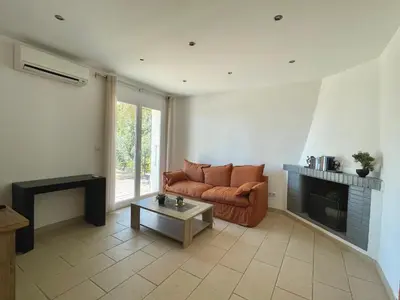 a living room with a couch and a fireplace at Villa piscine Sagone Paradise avec magnifique vue mer in Sagone