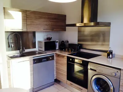 a kitchen with a sink and a dishwasher at Villa piscine Sagone Paradise avec magnifique vue mer in Sagone