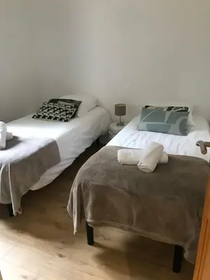 two beds sitting next to each other in a bedroom at Villa piscine Sagone Paradise avec magnifique vue mer in Sagone