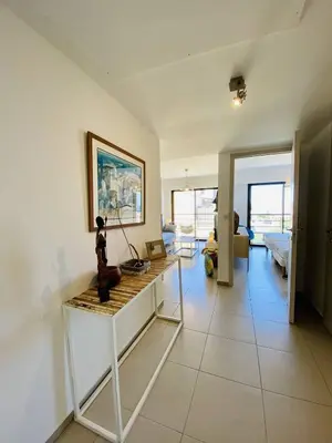 a living room with a table and a couch at Coté Plage pied dans l'eau vue mer in Propriano