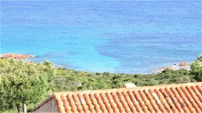 a view of the blue ocean from a roof at Maison 4 pièces, vue panoramique, piscine, climatisation, près de Palombaggia in Porto-Vecchio