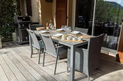 a dining table and chairs on a patio at Appartement Les Hameaux de Pinarello in Sainte-Lucie de Porto-Vecchio