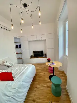a bedroom with a bed and a table at Suite Letizia in Ajaccio