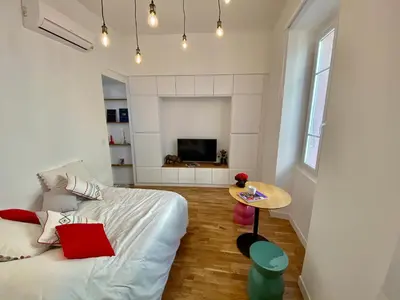 a living room with a bed and a table at Suite Letizia in Ajaccio