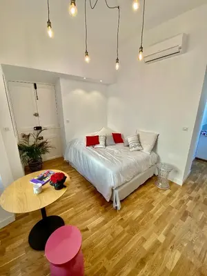 a bedroom with a bed and a table in it at Suite Letizia in Ajaccio