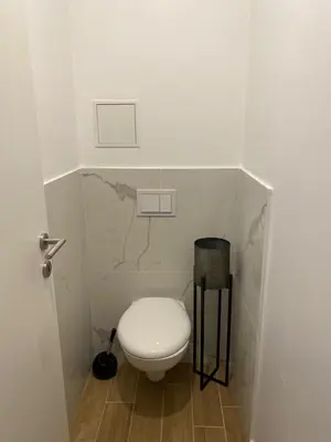 a bathroom with a white toilet in a room at Hotel U Catagnu in San-Nicolao