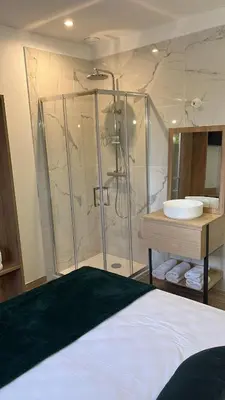 a bathroom with a shower and a sink at Hotel U Catagnu in San-Nicolao