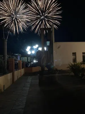 a statue in front of a building with fireworks at Hôtel La Demeure Coloniale in Moriani Plage