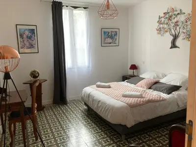 a bedroom with a bed and a window at Hôtel La Demeure Coloniale in Moriani Plage