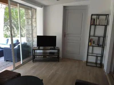 a living room with a television on a table and a door at Chalet Conca in Conca