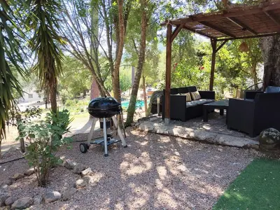 a barbecue grill in a backyard with a pavilion at Chalet Conca in Conca