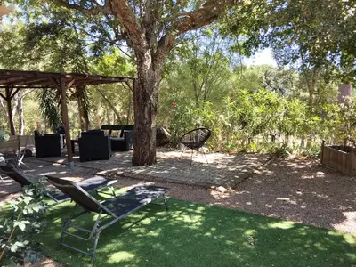 two chairs and a table under a tree at Chalet Conca in Conca