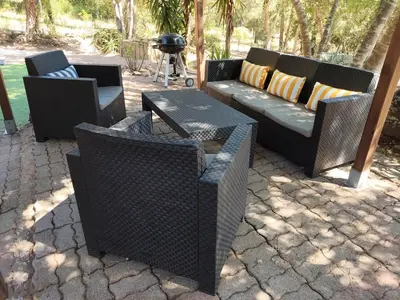 a patio with three chairs and a couch and tables at Chalet Conca in Conca