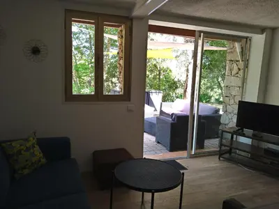 a living room with a couch and a table and a television at Chalet Conca in Conca