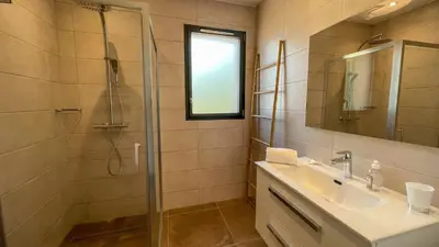 a bathroom with a sink and a shower at Tres belle villa neuve vue mer avec piscine chauffee in Sainte-Lucie de Porto-Vecchio