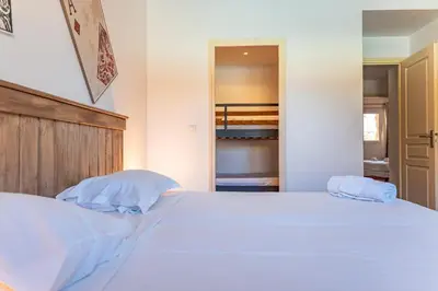 a bedroom with a large white bed with two pillows at Villa Calyaunati Di San Ciprianu in Lecci