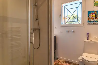a bathroom with a shower and a toilet at Villa Calyaunati Di San Ciprianu in Lecci