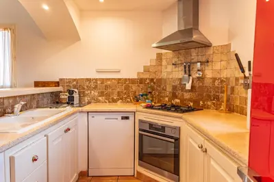 a kitchen with a sink and a stove top oven at Villa Calyaunati Di San Ciprianu in Lecci