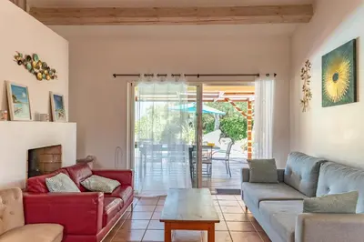 a living room with a couch and a table at Villa Calyaunati Di San Ciprianu in Lecci