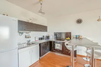 a kitchen with brown cabinets and a counter top at Cappella in Ajaccio