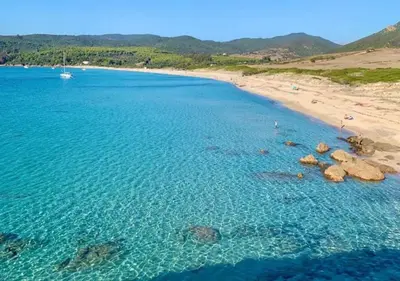 an aerial view of a beach with rocks in the water at Santa Lina in Ajaccio