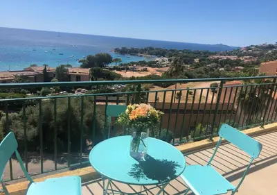 a table with a vase of flowers on a balcony at Santa Lina in Ajaccio