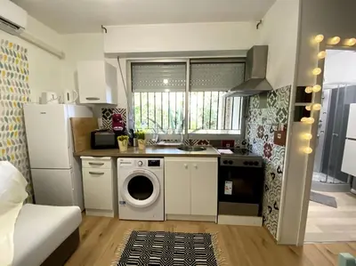 a kitchen with a washer and dryer in a room at studio cappella in Ajaccio