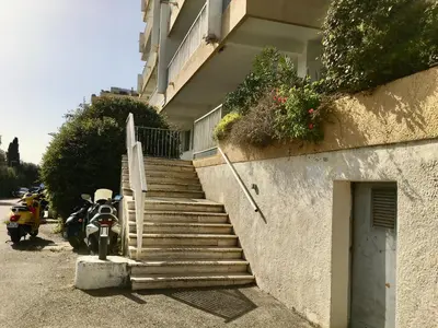 a motorcycle parked next to a building with stairs at studio cappella in Ajaccio
