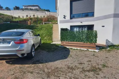 a silver car parked in front of a house at Corse et Zen BULLE ZEN 25 m² 2 pers + Bébé in Folelli