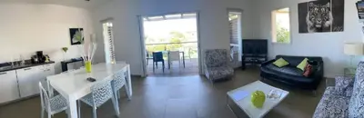 a living room with a couch and a table at La corse les pieds dans l'eau in Sainte-Lucie de Porto-Vecchio