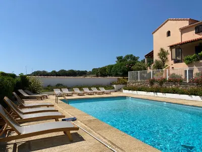 a swimming pool with lounge chairs and a house at Résidence Marie Diane - Laurier des Mers in Propriano