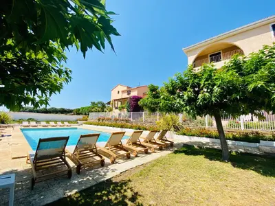 a row of chairs sitting next to a swimming pool at Résidence Marie Diane - Laurier des Bois in Propriano