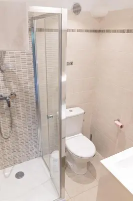 a bathroom with a toilet and a shower at Résidence Marie Diane - Duplex Coté Mer C in Propriano
