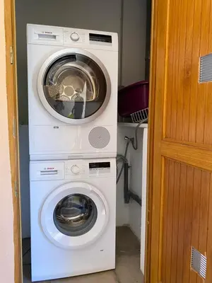 a washing machine and a dryer in a room at Résidence Marie Diane - Duplex Coté Mer D in Propriano
