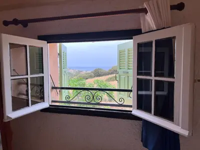 an open window with a view of a balcony at Résidence Marie Diane - Duplex Coté Mer D in Propriano