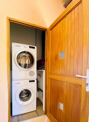 a washer and dryer in a tiny house at Résidence Marie Diane - Duplex Coté Mer E in Propriano