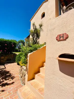 a building with a sign on the side of it at Résidence Marie Diane - Grand Duplex H in Propriano