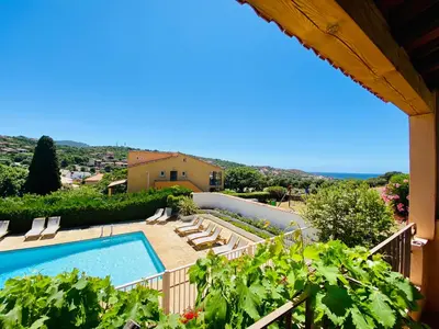 a villa with a swimming pool and some plants at Résidence Marie Diane - Grand Duplex H in Propriano
